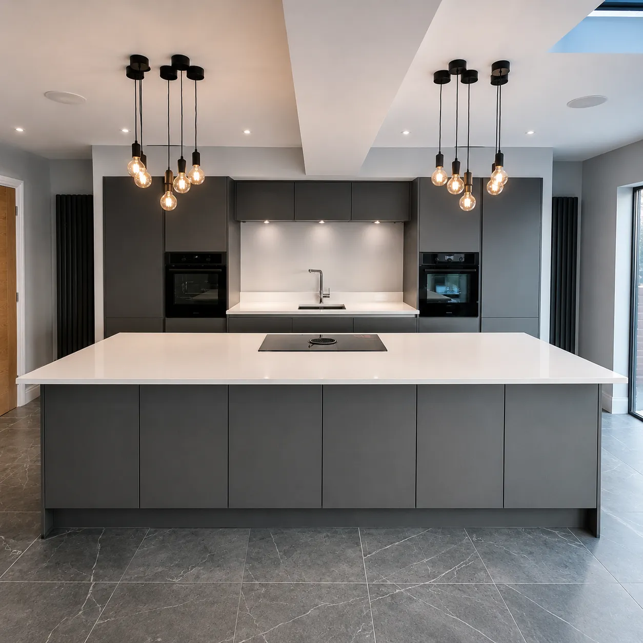 Grey handleless Nobilia kitchen with a large white island and pendant lighting